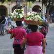 carrying flowers on their head